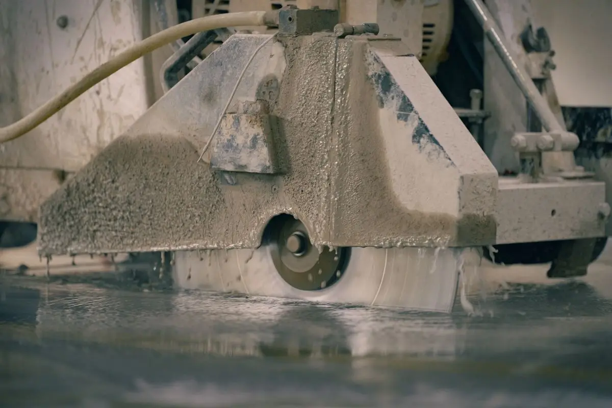 Concrete saw cutting a control joint into a slab